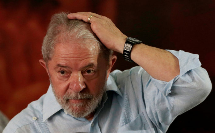 Former Brazilian president Luiz Inacio Lula da Silva reacts during a meeting with members of the Workers Party (PT) in Sao Paulo