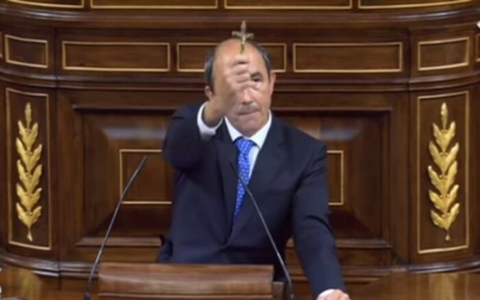 Deputado espanhol Francisco José Contreras levantando crucifixo de tio sacerdote martirizado